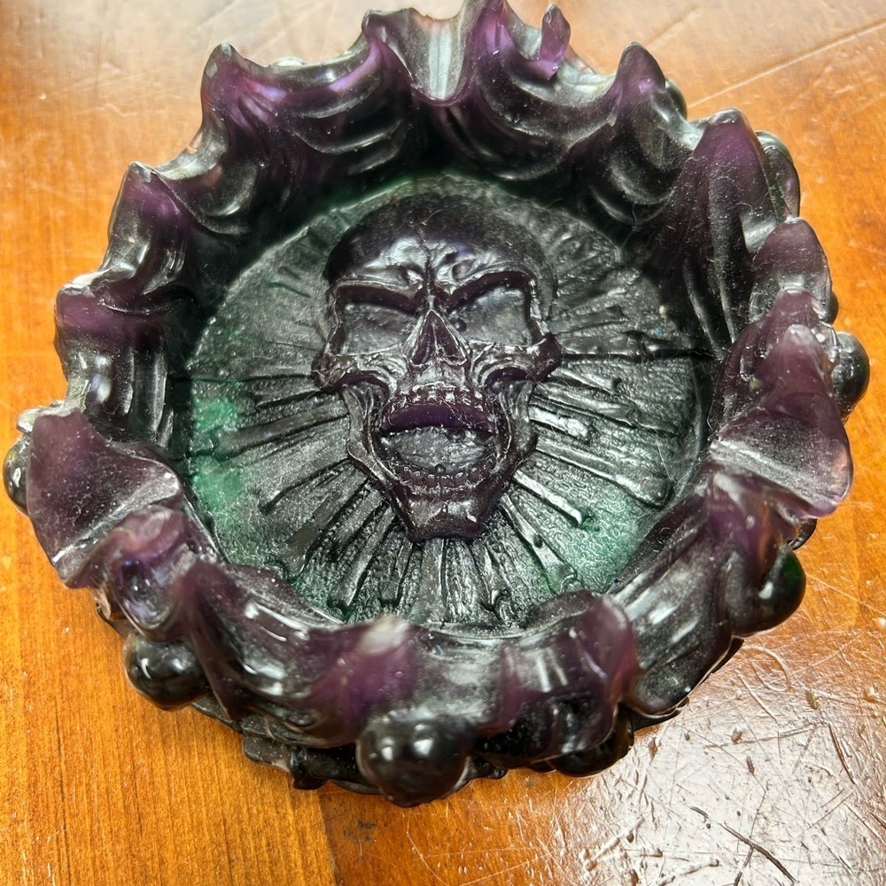 Resin skull ashtray- 5” by 2” , outside has skulls imbedded in resin- new